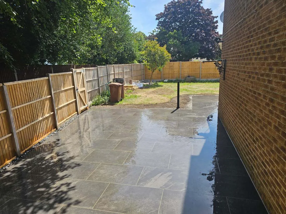 Large grey porcelain patio with new fencing by DJG Groundworks