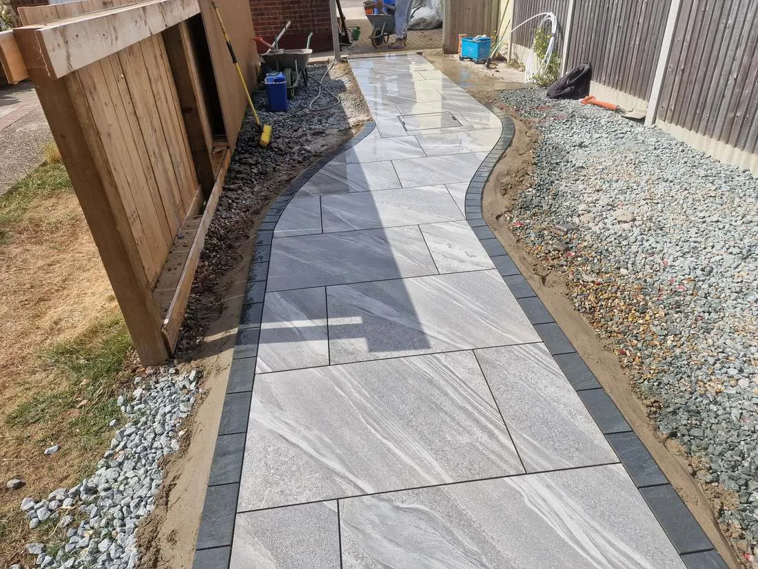 Curved porcelain path with block edging and gravel border by DJG Groundworks
