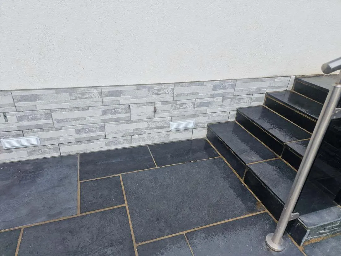 Stone cladding with slate paving and steps by DJG Groundworks