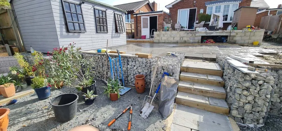 Gabion wall with steps to a raised patio by DJG Groundworks