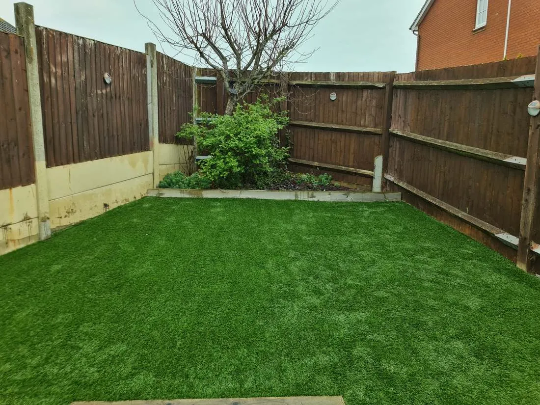 Artificial grass lawn with a timber edge by DJG Groundworks