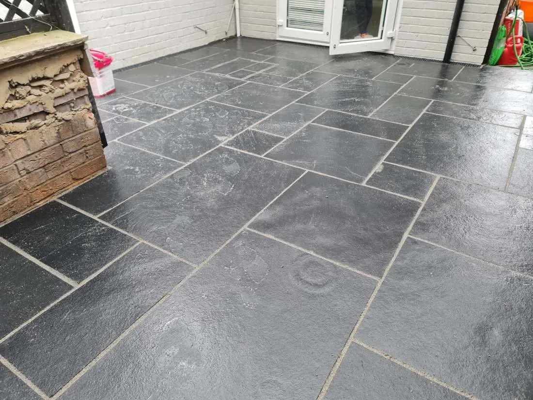 Natural slate patio with random-pattern paving by DJG Groundworks